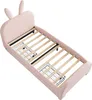 A pink upholstered bed frame with bunny ears on the headboard, shown from a diagonal angle. Voir les images du produit