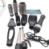 A collection of hair styling attachments and a hair dryer are laid out on a white surface. Anteprima dell’immagine prodotto
