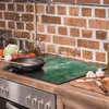 A kitchen counter with a stove, cooking utensils, and ingredients. Náhľad obrázku produktu