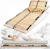 A woman sleeping on a mattress, with a bed frame shown above her. Produktbild-Vorschau