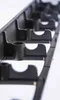 A close-up, angled view of a black plastic edging strip with multiple slots, likely for garden use. Náhľad obrázku produktu
