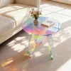 A round, iridescent acrylic side table with a book and a vase of flowers on it, placed next to a cream-colored sofa. Sunlight streams in, casting shadows on the floor. Anteprima dell’immagine prodotto