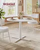 A white round dining table with chairs in a bright, airy room with large windows. Produktbild-Vorschau