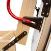 A close-up view of the mechanical components of a wooden attic ladder, showing metal brackets and a red handle. Podgląd zdjęcia produktu