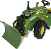 A close-up, angled view of a green toy tractor with a front plow attachment, set against a white background. Produktbild-Vorschau