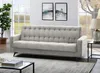 A modern living room with a sofa, artwork, and a plant. Produktbild-Vorschau
