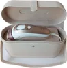 A rose gold and white Braun IPL hair removal device is placed inside its beige storage case. Podgląd zdjęcia produktu
