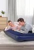 A couple is lying on an inflatable mattress, reading a book. Náhled obrázku produktu