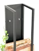 A black metal firewood rack with logs inside, against a white background. Podgląd zdjęcia produktu