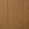 A close-up view of a wooden surface, likely a cabinet or furniture piece, showing the grain and texture of the wood. The lighting is even, highlighting the natural color and details of the material. Podgląd zdjęcia produktu