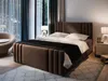 A bedroom scene with a large bed, nightstand, and armchair. Produktbild-Vorschau