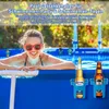 A woman in a pool smiles while holding drinks in pool cup holders. Produktbild-Vorschau
