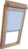 A wooden framed skylight window with a light blue roller blind partially lowered. Produktbild-Vorschau