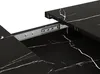 A close-up view of a black marble-patterned extendable dining table, showing the sliding mechanism. Anteprima dell’immagine prodotto