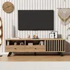 A TV stand with a TV mounted above it, in a living room setting. Náhľad obrázku produktu
