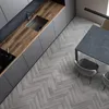 A modern kitchen and dining area with a herringbone floor. Produktbild-Vorschau