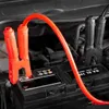 Close-up of car battery terminals with jumper cables attached. Podgląd zdjęcia produktu