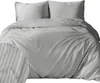 A neatly made bed with a duvet and pillows, featuring a striped pattern. Anteprima dell’immagine prodotto