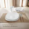 A table setting with white dinnerware, cutlery, and a mug, with text overlay. Náhled obrázku produktu
