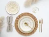 A table setting with plates, cutlery, a glass of wine, and decorative elements. Náhľad obrázku produktu