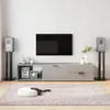A living room scene with a TV, media console, speakers, and a rug. Anteprima dell’immagine prodotto