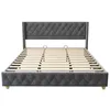 A grey upholstered bed frame with a slatted wooden base, shown from the front. Náhled obrázku produktu
