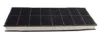 A rectangular activated carbon filter with a grid pattern on the black top surface and a white foam bottom. Produktbild-Vorschau