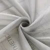 A close-up view of a light gray fabric with text printed on it, folded into a swirl. Produktbild-Vorschau