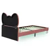 A pink bed frame with a black headboard shaped like a bow, shown from the side against a white background. Anteprima dell’immagine prodotto