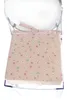 A close-up view of a pink seat cushion with a floral pattern, placed on a clear plastic chair. Produktbild-Vorschau