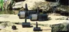 Several pond pumps are displayed on rocks next to a pond with a waterfall in the background. Produktbild-Vorschau