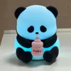A cute, illuminated panda toy holding a baby bottle. Produktbild-Vorschau