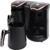 A black electric Turkish coffee machine with rose gold accents and two black cups. Produktbild-Vorschau