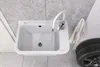 A white sink with a faucet is shown in a garage or workshop setting, with a tire and a towel visible. Anteprima dell’immagine prodotto