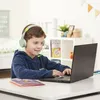 A young boy wearing headphones is using a laptop in a room. Produktbild-Vorschau