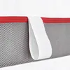 A close-up view of a mattress edge showing a red zipper, gray mesh fabric, and a white fabric loop. Anteprima dell’immagine prodotto