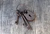 A set of old, rusty keys and a padlock are placed on a wooden surface. Náhľad obrázku produktu