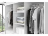 Interior view of a modern white wardrobe with clothes neatly organized on shelves and hanging on a rod. Produktbild-Vorschau