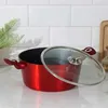 A red pot with a glass lid sits on a white countertop with a tiled backsplash. Voir les images du produit