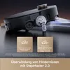 A close-up marketing image of a robotic vacuum cleaner, highlighting its ability to overcome obstacles. Produktbild-Vorschau