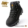 A studio shot of a black work boot with green accents. Produktbild-Vorschau