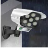 A solar-powered security light with motion sensor mounted on a wall during a rain shower. Produktbild-Vorschau