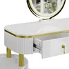 A close-up view of a white vanity table with gold accents and an open drawer. Náhled obrázku produktu