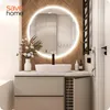 A modern bathroom vanity with a round LED mirror, sink, and faucet. Náhled obrázku produktu