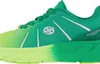 A close-up side view of a green and yellow running shoe. Produktbild-Vorschau