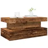 A wooden coffee table with a book, a glass, and a small plant on top, set against a white background. Podgląd zdjęcia produktu