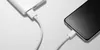 A white power bank is connected to a smartphone with a white USB-C cable. Produktbild-Vorschau
