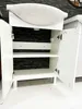 A white bathroom vanity with the doors open, showing shelves and a black tiled back. Náhľad obrázku produktu