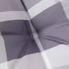 A close-up view of a gray and white checkered cushion. Produktbild-Vorschau