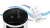 A tower fan and its remote control are shown against a white background with blue wavy lines. Produktbild-Vorschau